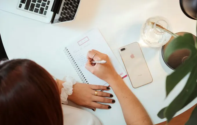 Illustrative text-on-B-roll reference: a creator planning at a desk