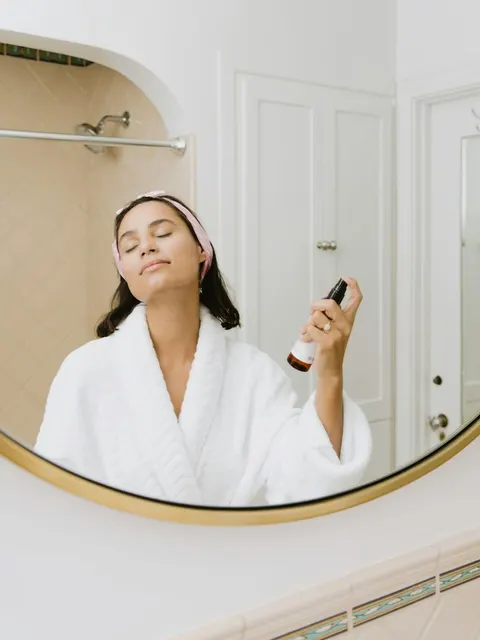 Woman using a facial mist during her morning skincare routine